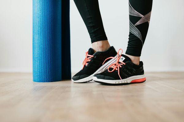 Close-up of athletic shoes on a wooden floor, ready for action.